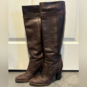 Michael Kors pebbled leather high heel pull on boots with brogue detailing.